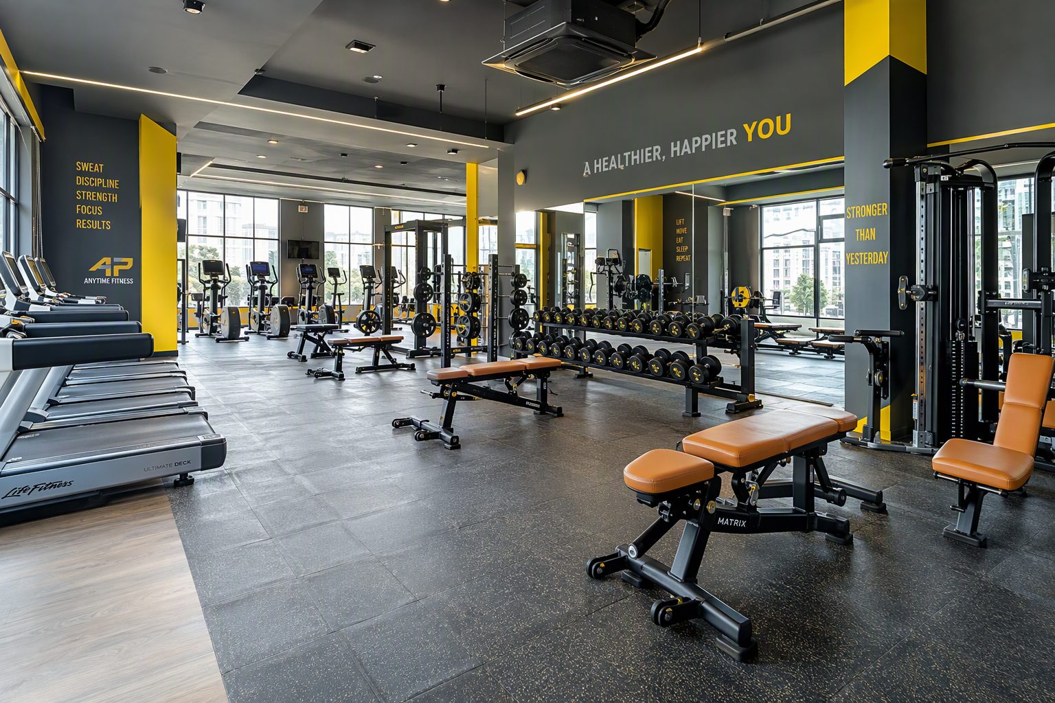 Spacious training floor with cardio machines and dumbbell racks at Smart Fit Gym